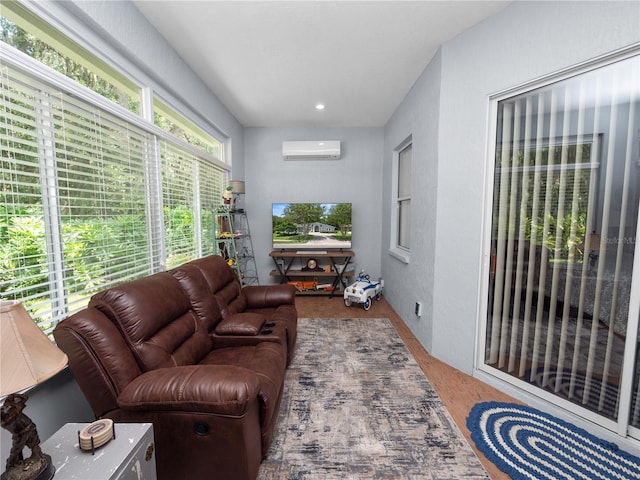 living room with a wall unit AC and hardwood / wood-style floors