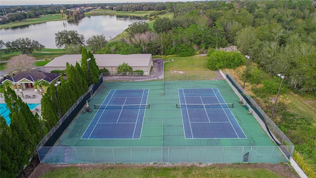 view of sport court with a water view