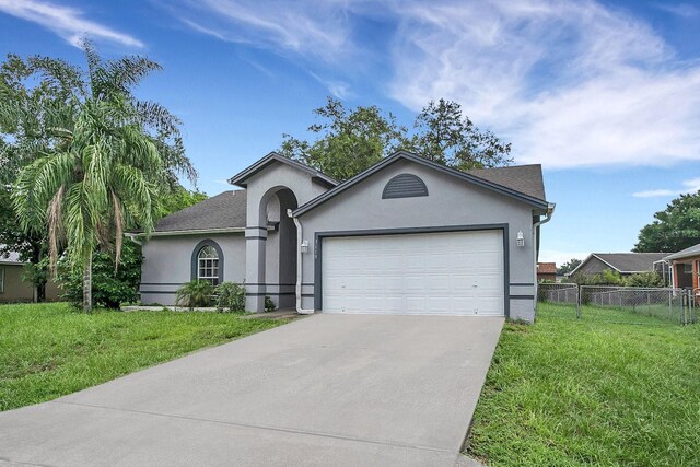 view of front of house with a front yard and a garage