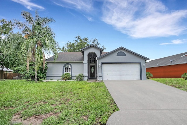 ranch-style home with a garage and a front yard