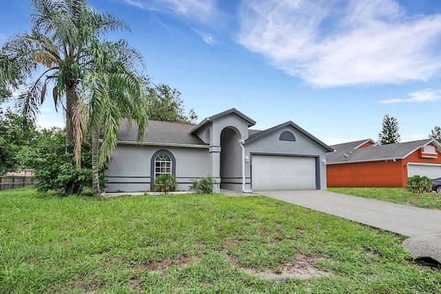 ranch-style home with a garage and a front lawn