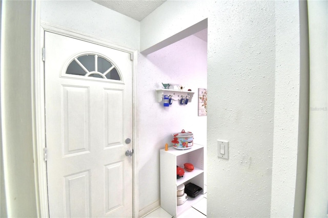 foyer entrance featuring a textured ceiling