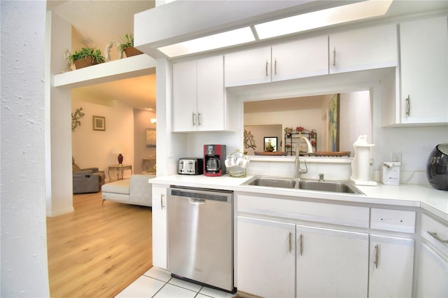 kitchen with white cabinetry, sink, light hardwood / wood-style flooring, and dishwasher