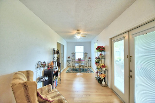 interior space featuring a textured ceiling, light hardwood / wood-style flooring, and french doors