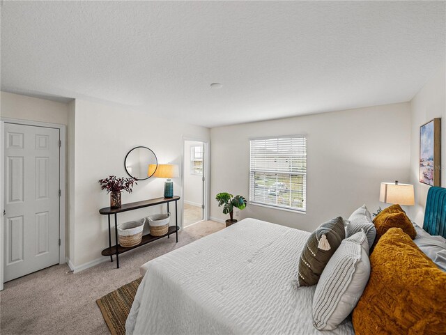 carpeted bedroom featuring a textured ceiling