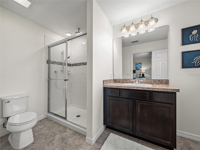 bathroom with toilet, an enclosed shower, vanity, and tile patterned floors