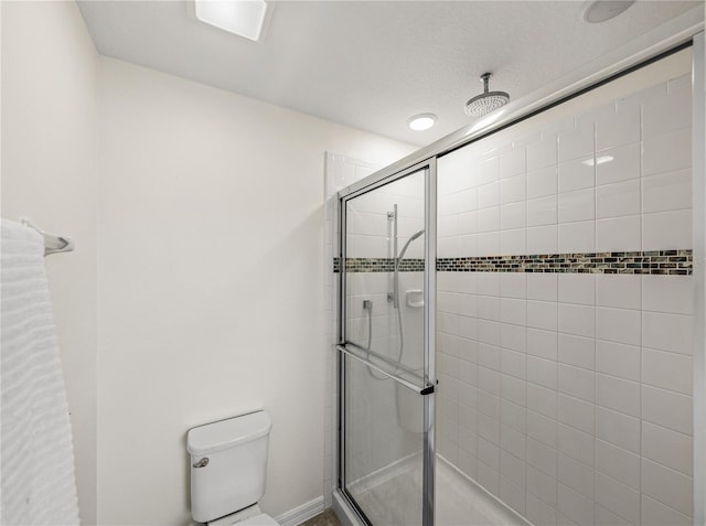 bathroom with toilet and walk in shower