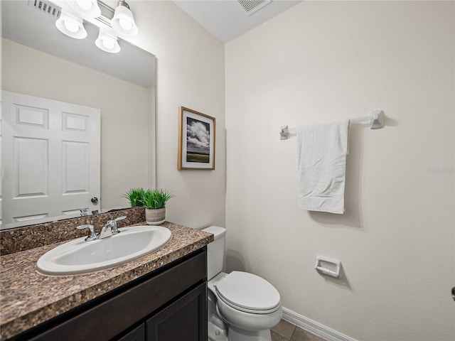 bathroom featuring tile patterned flooring, vanity, and toilet