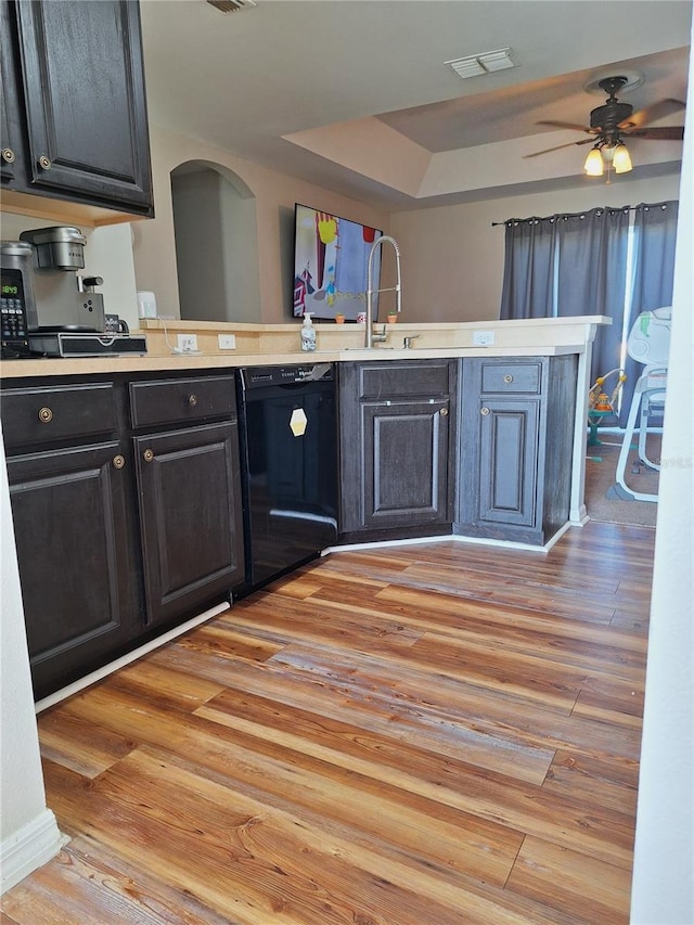 kitchen featuring light countertops, visible vents, a sink, light wood-type flooring, and dishwasher