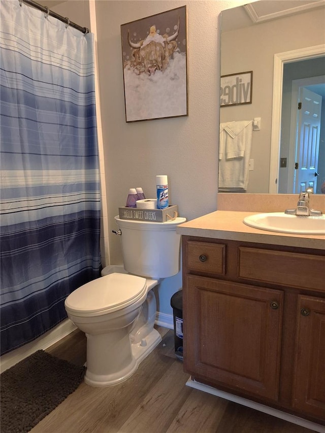 full bathroom featuring vanity, curtained shower, wood finished floors, and toilet