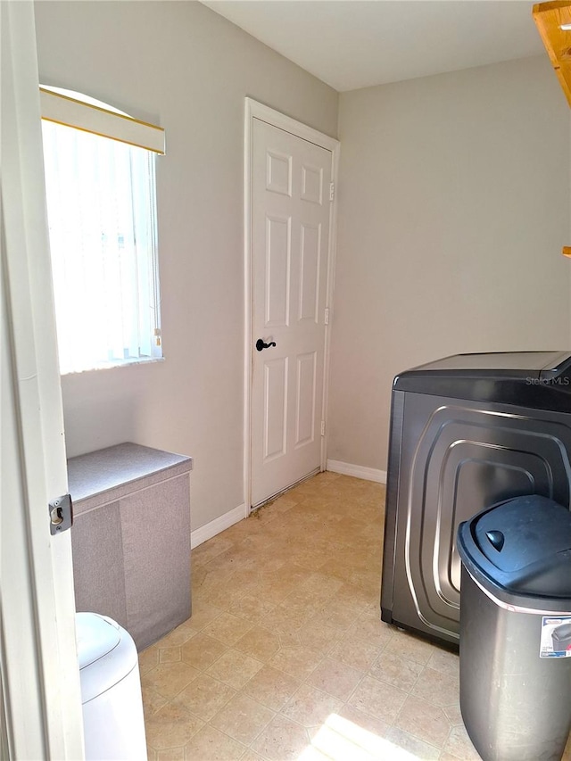 clothes washing area featuring light tile patterned flooring