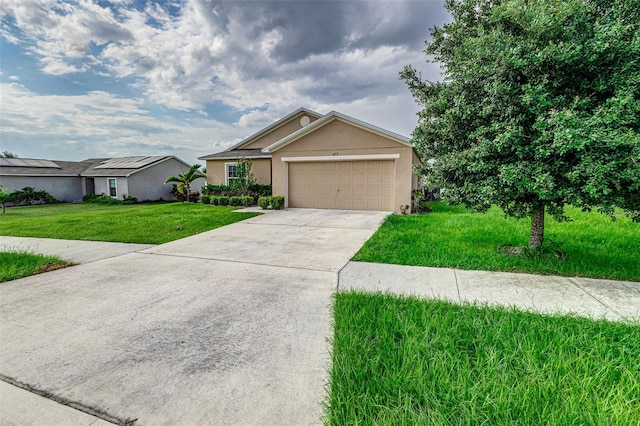 view of front of home featuring solar panels, a garage, and a front lawn