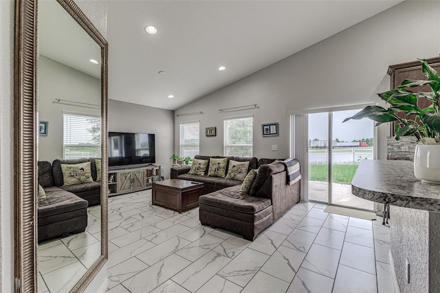 living room with high vaulted ceiling and light tile patterned flooring