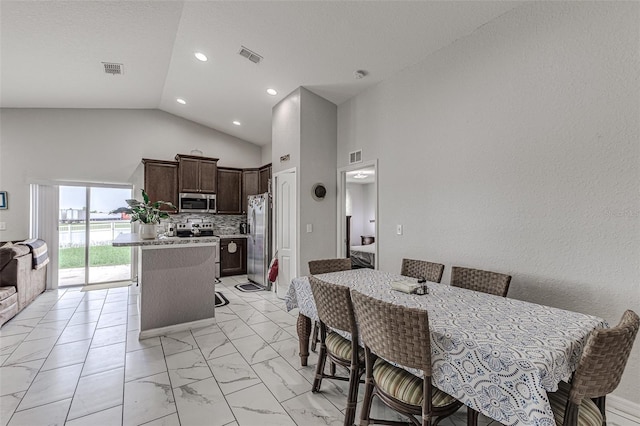 tiled dining area with high vaulted ceiling