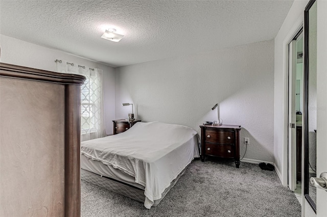 carpeted bedroom with a textured ceiling