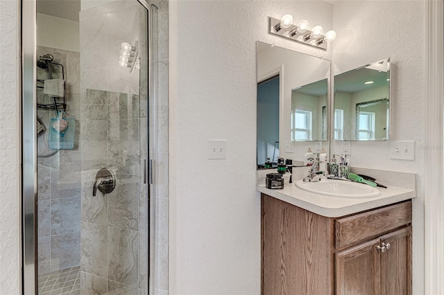 bathroom featuring vanity and a shower with shower door