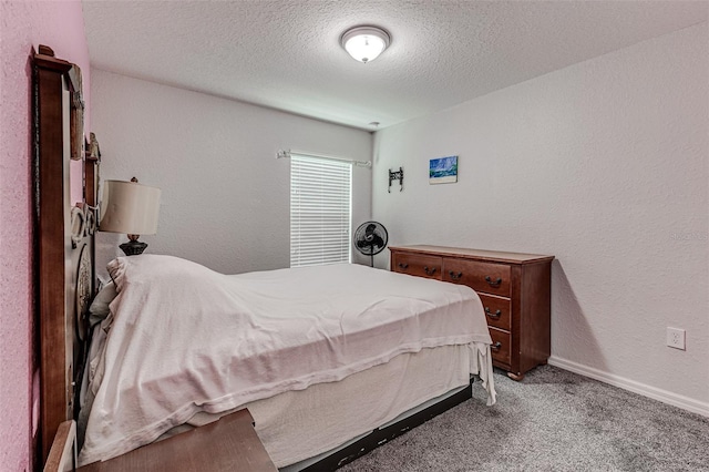 carpeted bedroom featuring a textured ceiling