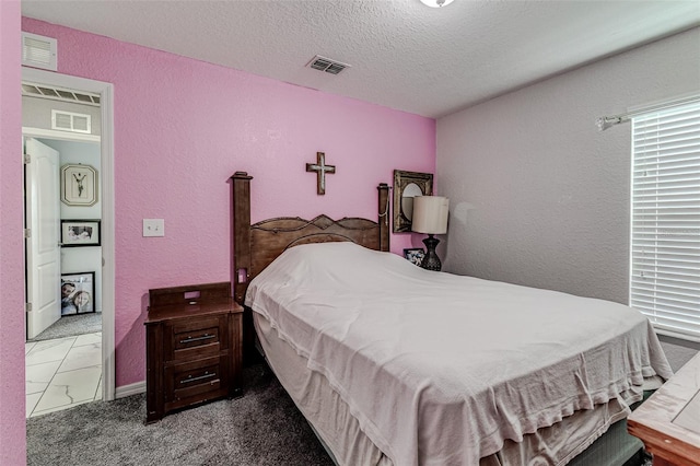 bedroom featuring a textured ceiling and tile patterned floors