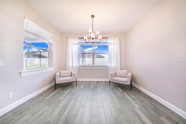 unfurnished room featuring hardwood / wood-style flooring and a notable chandelier