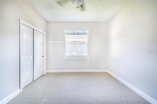 unfurnished bedroom with a closet, ceiling fan, and light carpet