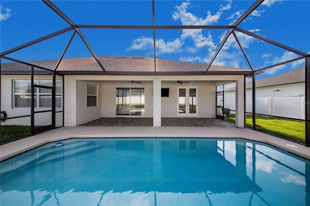 view of pool with ceiling fan, a lanai, a patio area, and french doors