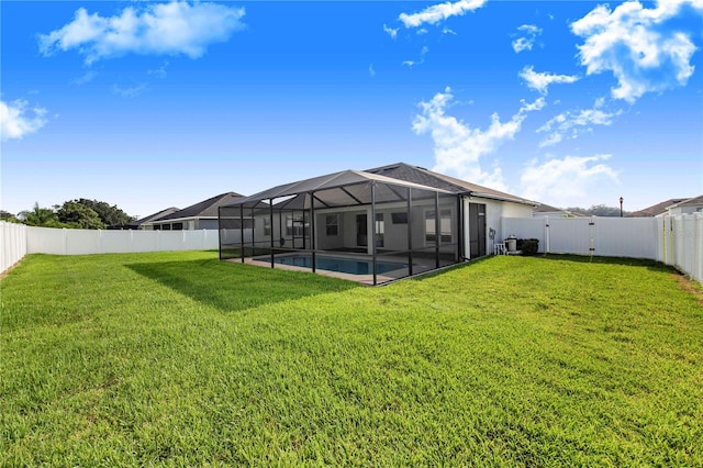 view of yard featuring glass enclosure and a fenced in pool