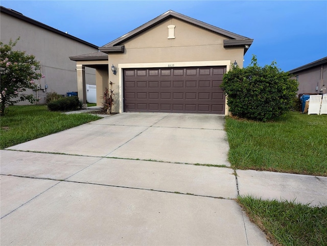 view of front of home featuring a front yard and a garage