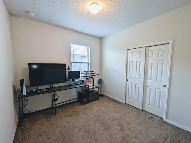 carpeted office with a textured ceiling