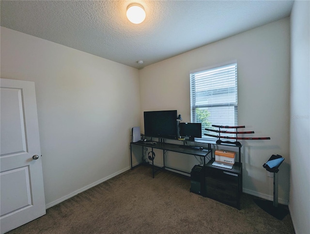 carpeted home office featuring a textured ceiling