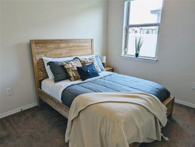 bedroom featuring dark carpet