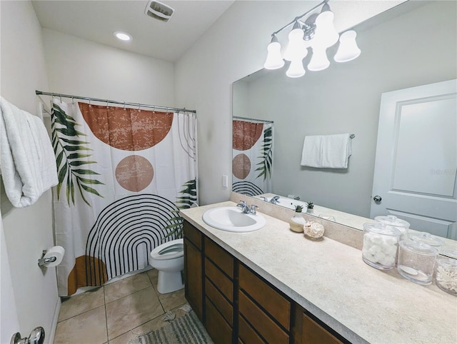 bathroom featuring tile patterned flooring, an inviting chandelier, vanity, and toilet