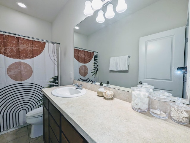 bathroom featuring toilet, tile patterned flooring, and vanity