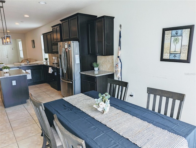 tiled dining area featuring sink