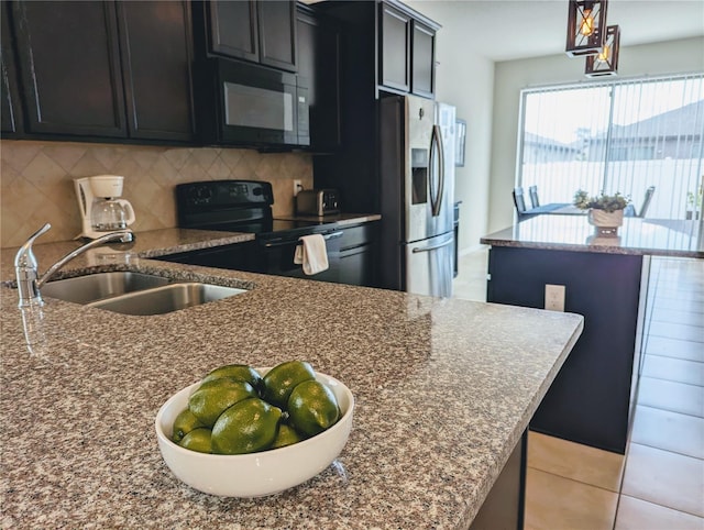 kitchen featuring decorative backsplash, stone counters, sink, black appliances, and light tile patterned floors