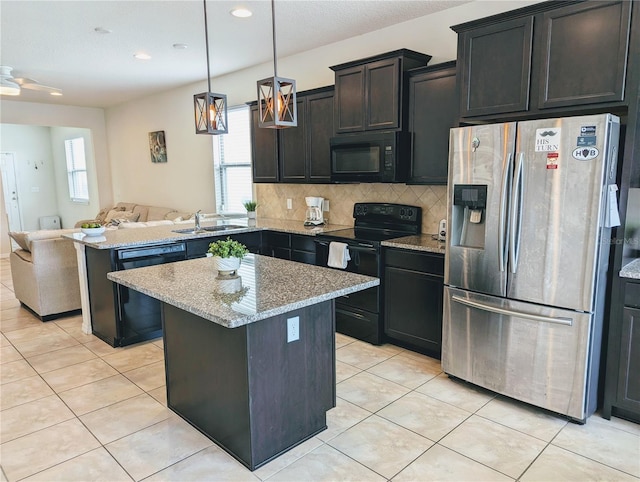 kitchen featuring a center island, ceiling fan, black appliances, and tasteful backsplash