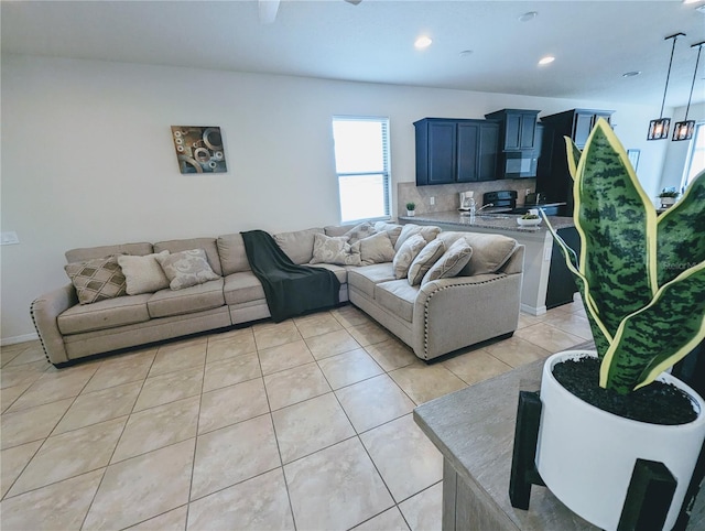 living room featuring sink and light tile patterned floors