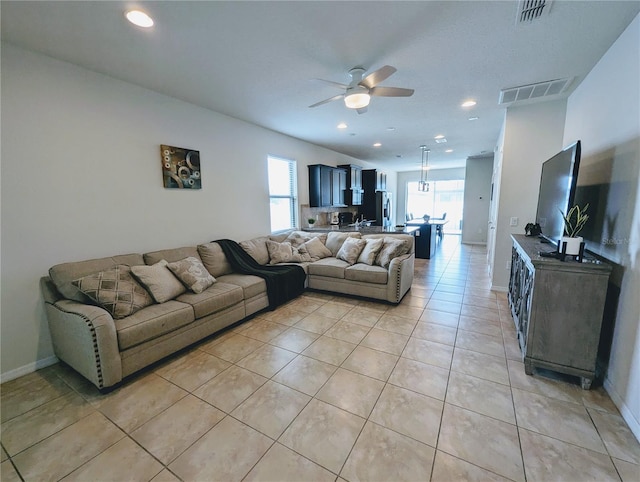 living room with ceiling fan, light tile patterned floors, and sink