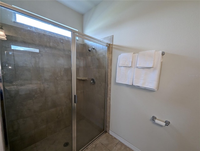 bathroom with tile patterned flooring and an enclosed shower