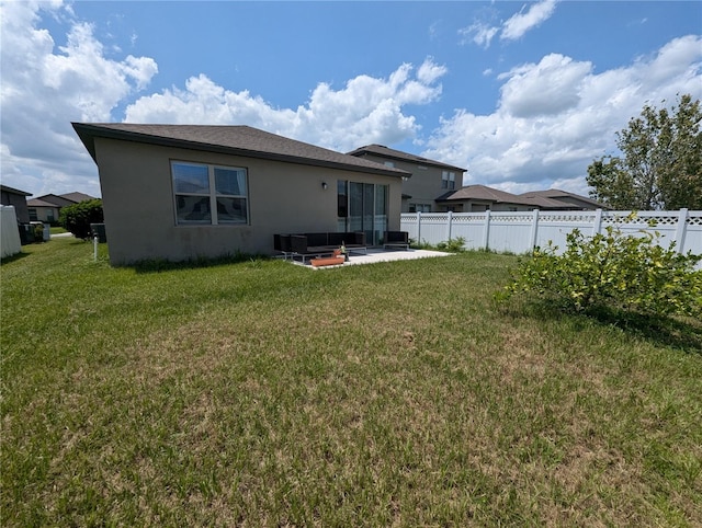 rear view of property featuring a lawn, a patio area, and cooling unit