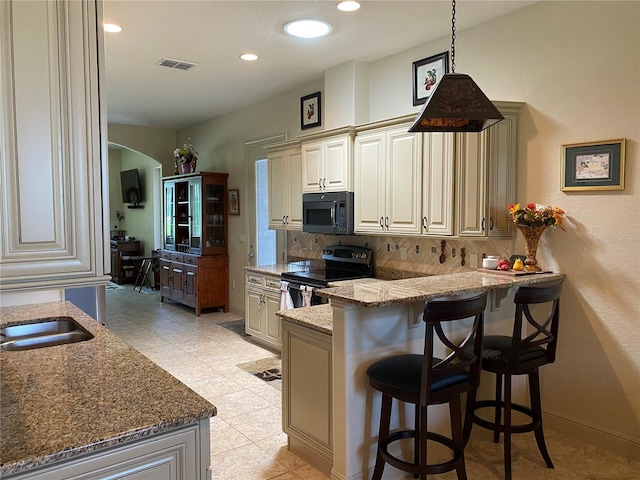 kitchen featuring decorative backsplash, light tile patterned floors, stainless steel electric range, and stone counters