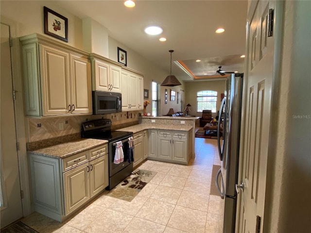 kitchen with electric range, stone countertops, decorative light fixtures, a peninsula, and freestanding refrigerator