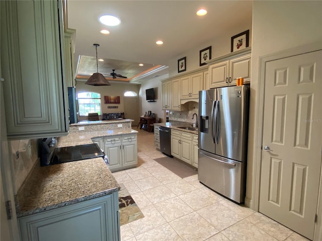 kitchen featuring ceiling fan, a raised ceiling, backsplash, stainless steel refrigerator with ice dispenser, and black dishwasher