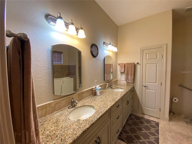 bathroom with double vanity and tile patterned floors