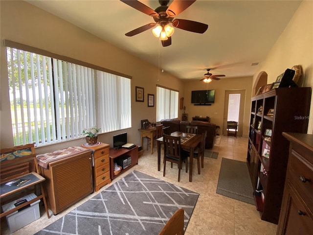 interior space featuring ceiling fan, light tile patterned floors, and plenty of natural light