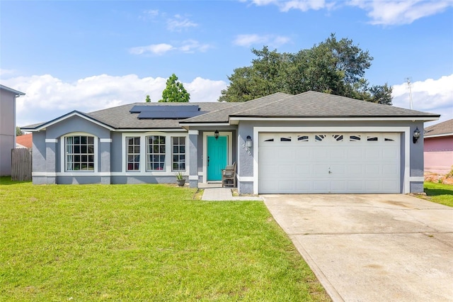 single story home with solar panels, a garage, and a front lawn