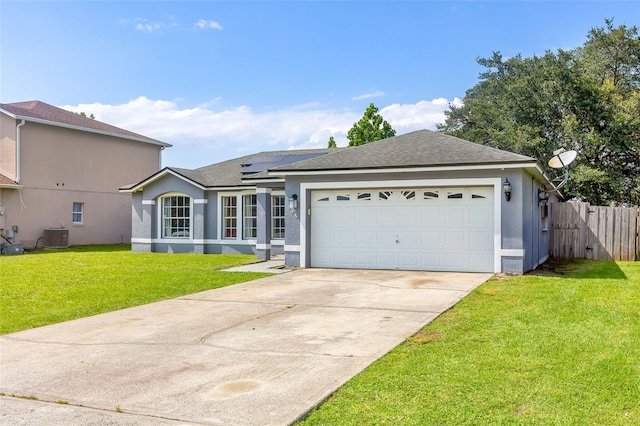 single story home with a garage, central air condition unit, a front lawn, and solar panels