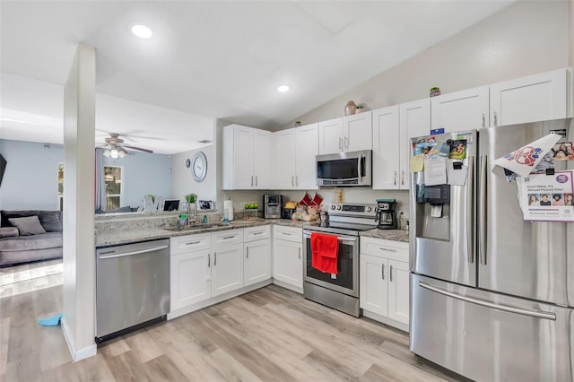 kitchen with white cabinetry, light hardwood / wood-style flooring, light stone counters, ceiling fan, and stainless steel appliances