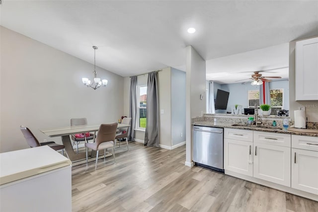 kitchen featuring light wood-type flooring, ceiling fan with notable chandelier, white cabinets, dishwasher, and sink