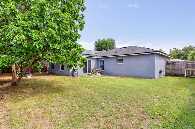 rear view of property with a lawn