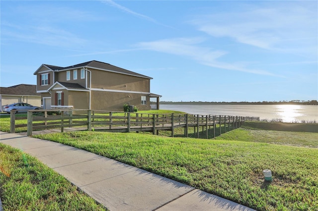 view of home's exterior featuring a lawn and a water view